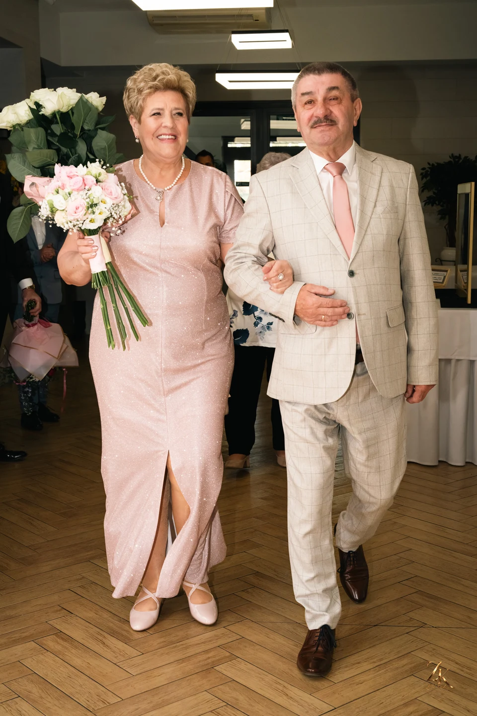 Jubilaci z bukietem podczas przyjęcia — 50. rocznica ślubu